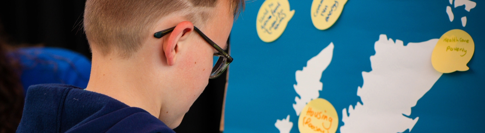 a young person looking at a map of scotland