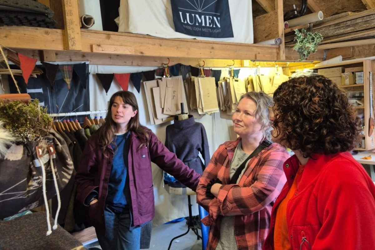 A small group of people visiting a textile studio