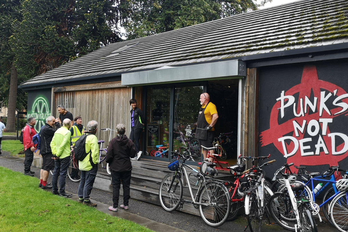A group of cyclists visiting a community bike shed
