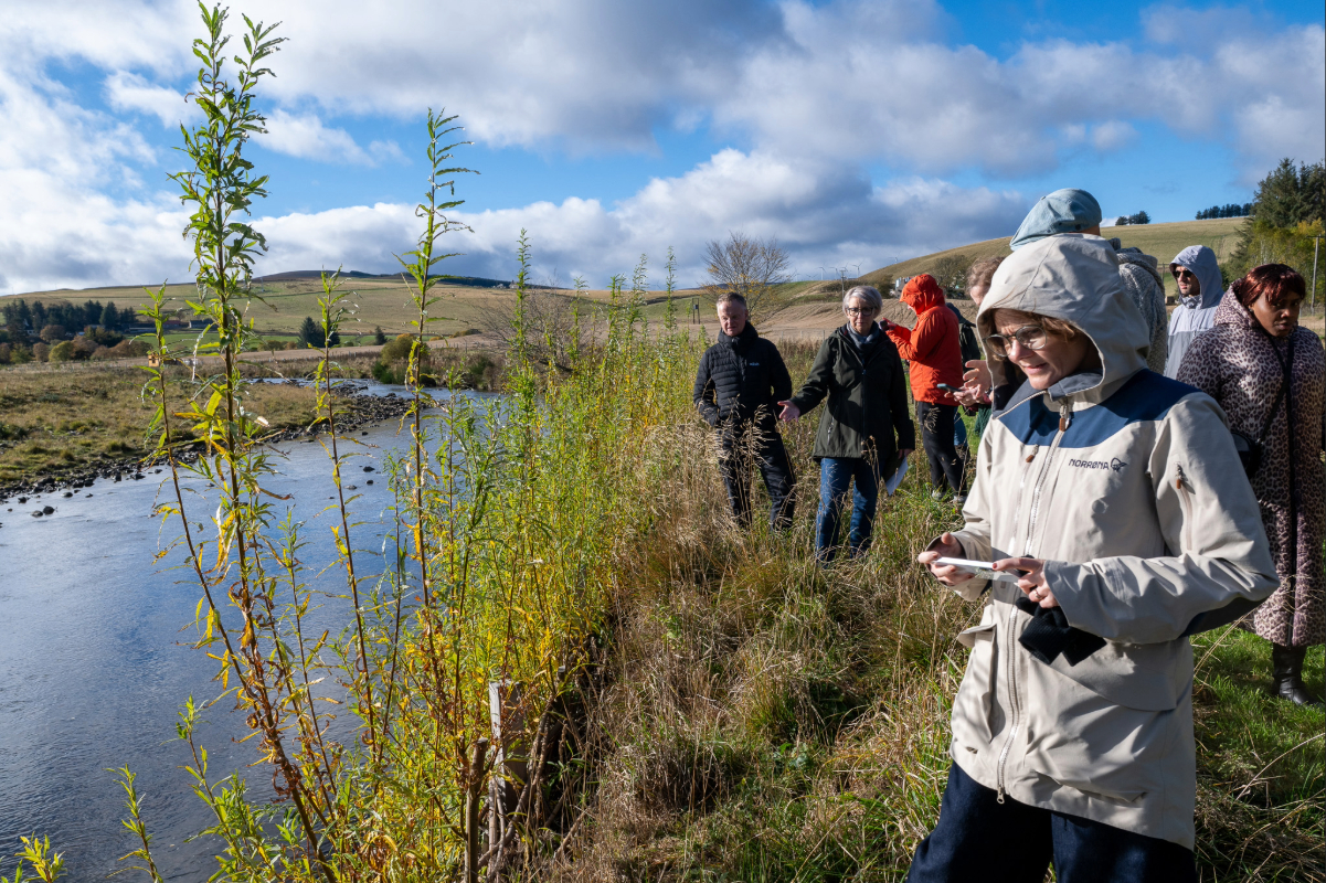 A group of people standing by a river
