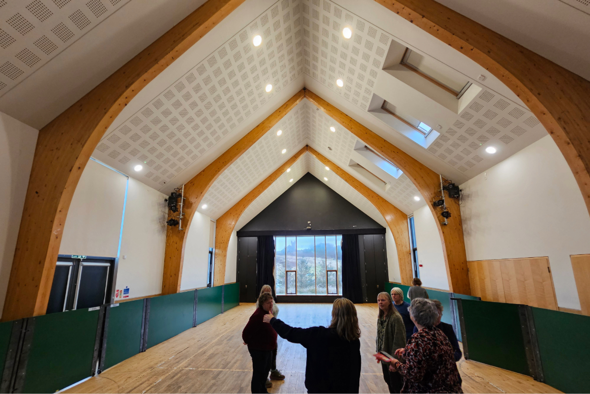 A small group of people viewing a converted village hall